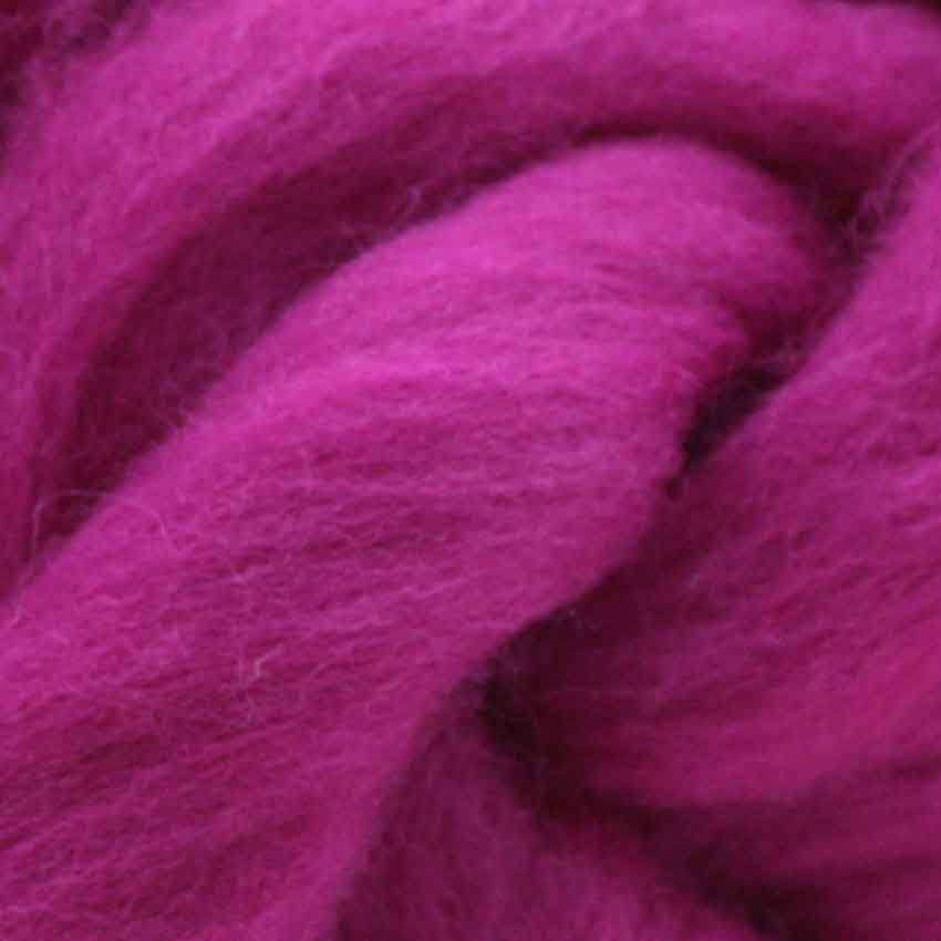 close up of corrie wool top for felting in magenta colour