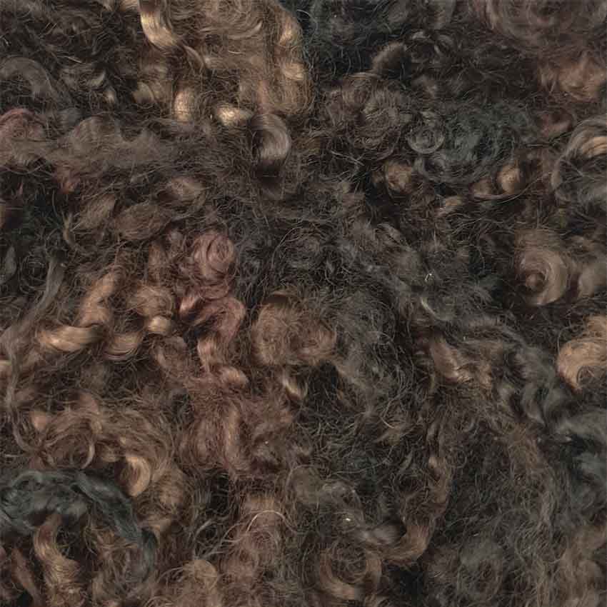 Close up of brunette mohair curls showing varying shades of dark brown colours