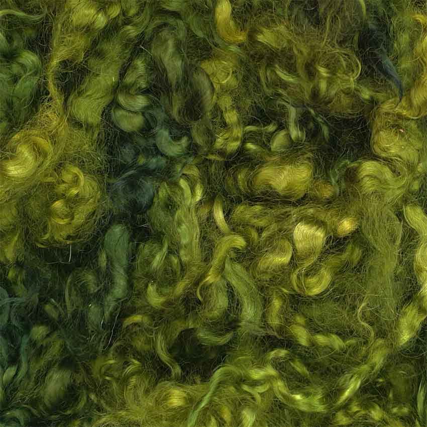 Close up of green party mohair curls showing varying shades of green colours