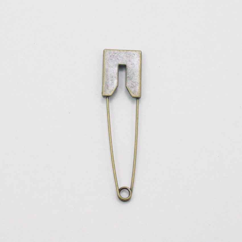 Old Brass coloured metal pin with flat edged head.