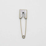 Old Brass coloured metal pin with flat edged head.